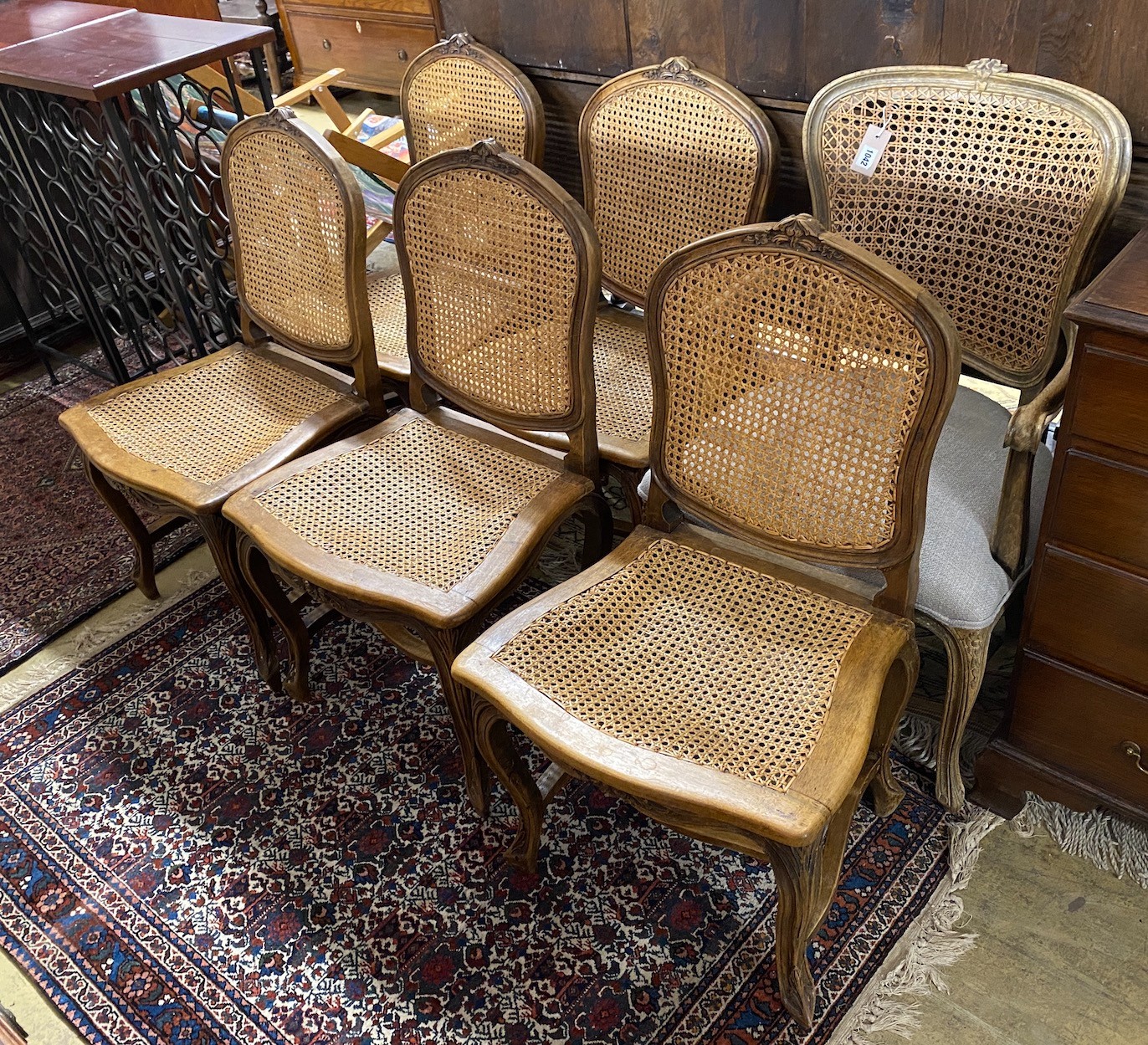 A set of six French carved beech dining chairs and a similar elbow chair